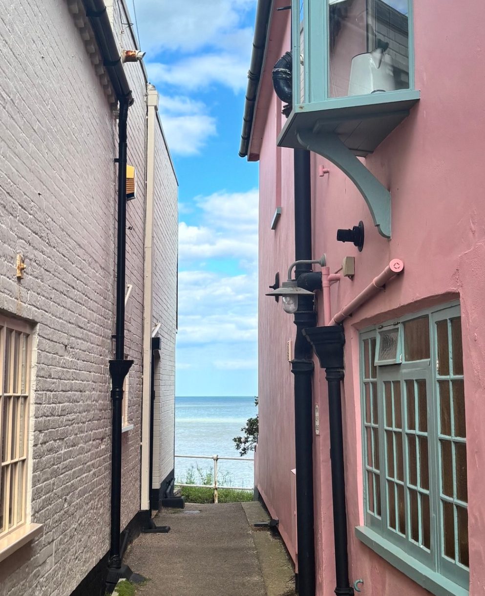 Walls are closing in Narrow, old walkway between two very old cottages, leading to the sea.
